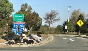 Trash collecting on Caltrans I-80/I-580 on-ramp, Berkeley, CA.