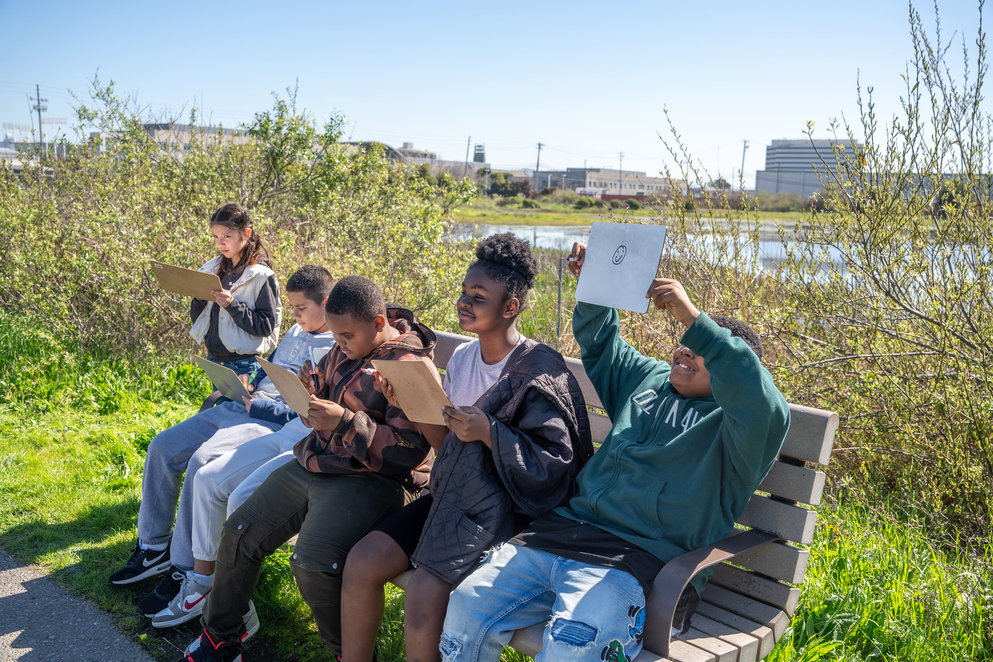 kids on the shoreline playing an educational game