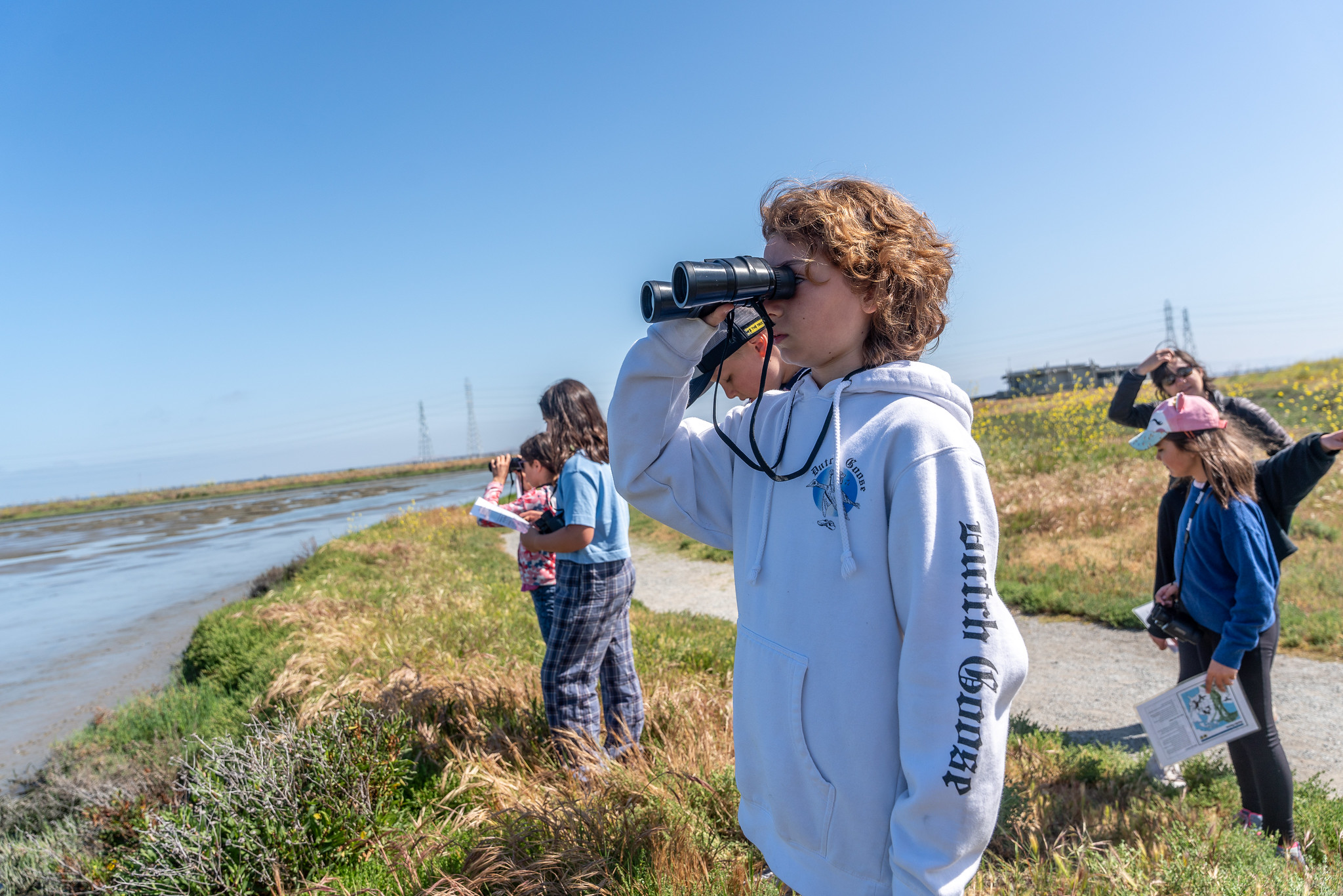 Children looking at the Bay through binoculars