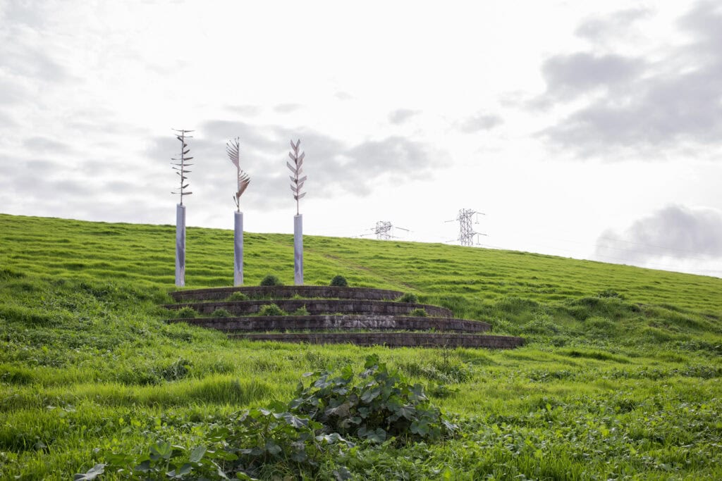 art sculptures on a hill covered in green grass